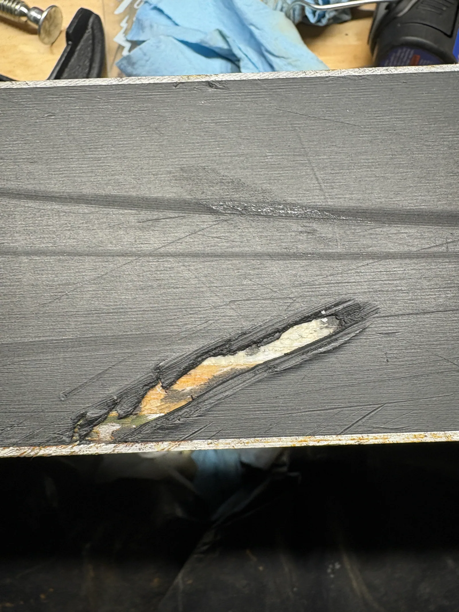 Exposed snowboard core before base repair